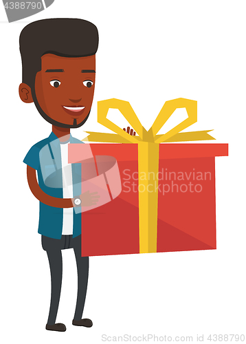 Image of Joyful african-american man holding box with gift.