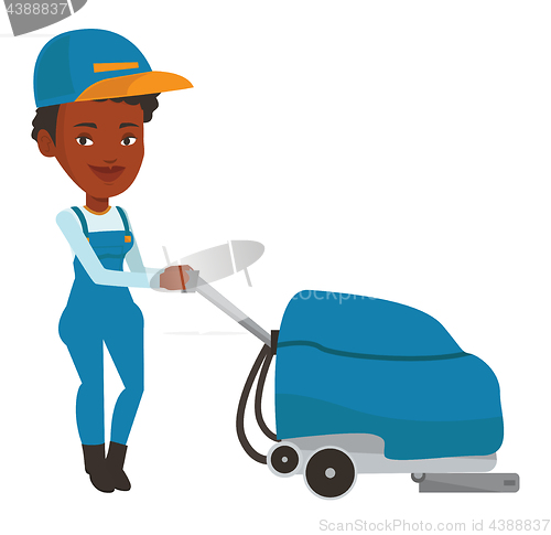 Image of African worker cleaning store floor with machine.