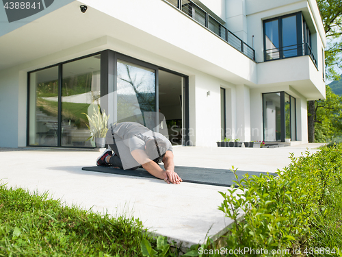 Image of man doing morning yoga exercises