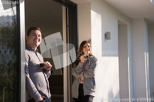 Image of couple enjoying on the door of their luxury home villa