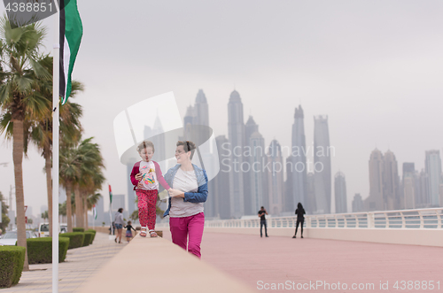 Image of mother and cute little girl on the promenade