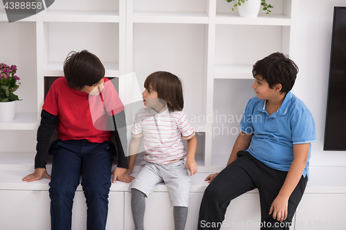 Image of young boys posing on a shelf