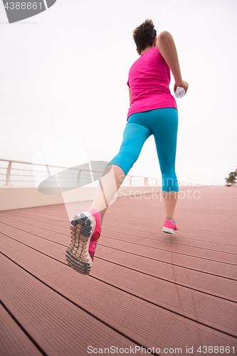 Image of woman busy running on the promenade