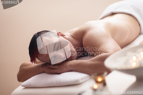 Image of handsome man resting in a spa massage center