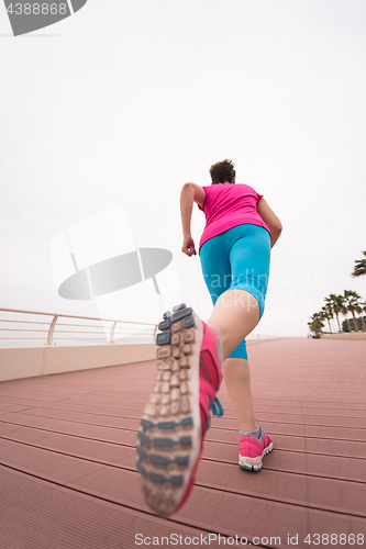 Image of woman busy running on the promenade