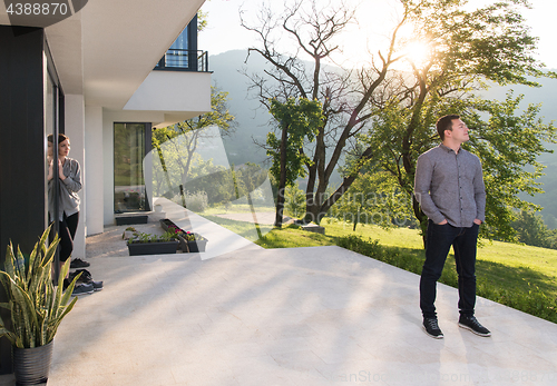 Image of man in front of his luxury home villa