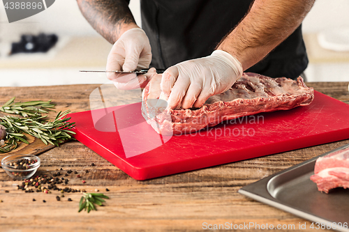 Image of Man cooking meat steak on kitchen