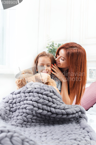 Image of A little cute girl enjoying, playing and creating with toy with mother