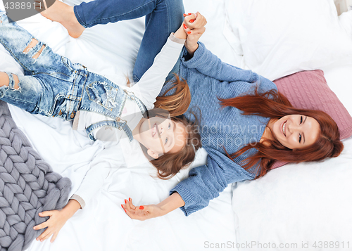 Image of A little cute girl enjoying, playing and creating with toy with mother