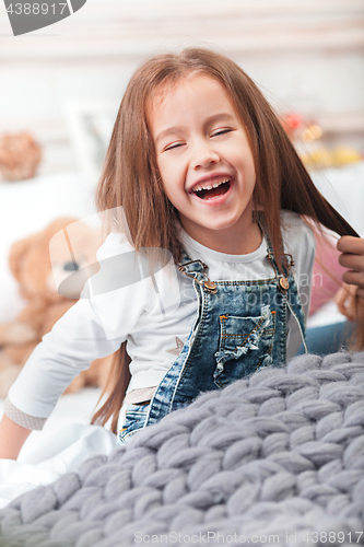 Image of A little cute girl enjoying, playing and creating with mother hands