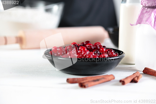 Image of A cook with eggs on a rustic kitchen against the background of men\'s hands