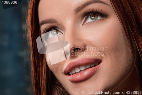 Image of Beautiful woman face portrait close up on dark