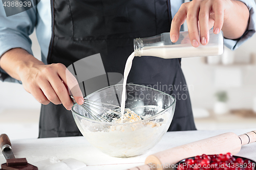 Image of A cook with eggs on a rustic kitchen against the background of men\'s hands