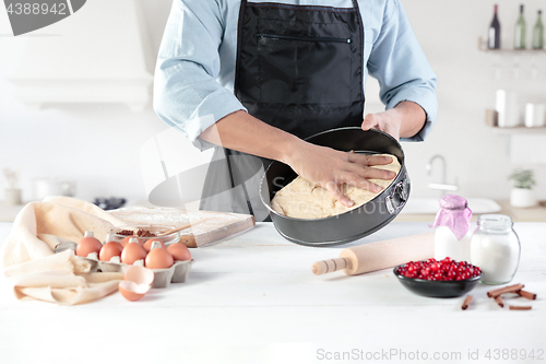 Image of A cook with eggs on a rustic kitchen against the background of men\'s hands