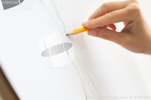 Image of artist with pencil drawing picture at art studio