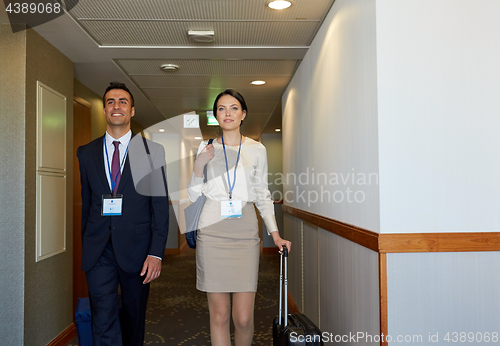 Image of business team with travel bags at hotel corridor