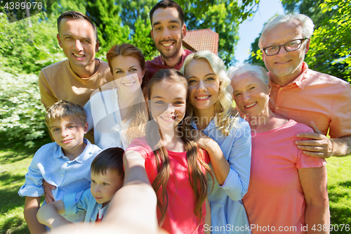 Image of happy family taking selfie in summer garden