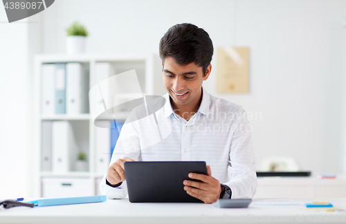 Image of businessman working with tablet pc at office