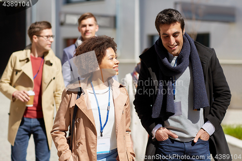 Image of business team with conference badges in city