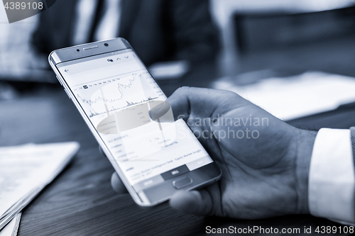 Image of Close up of businessman using mobile smart phone.