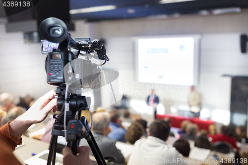 Image of Television broadcasted press conference.