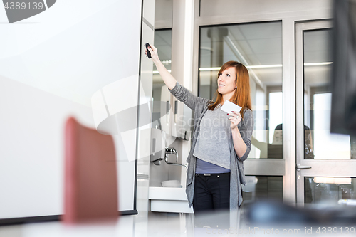 Image of Woman giving presentation in lecture hall at university.