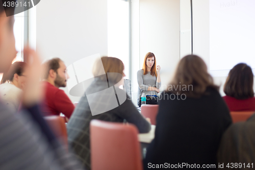 Image of Woman giving presentation in lecture hall at university.