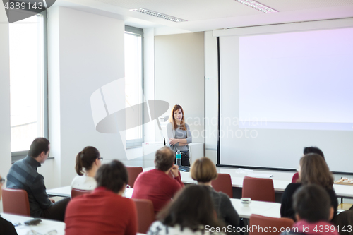 Image of Woman giving presentation in lecture hall at university.