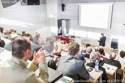 Image of Business speaker giving a talk at business conference event.