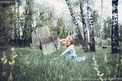 Image of Beautiful Blonde Woman Resting In The Grass