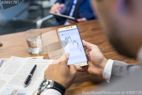 Image of Close up of businessman using mobile smart phone.