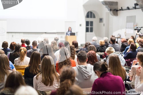 Image of Woman giving presentation in lecture hall at university.