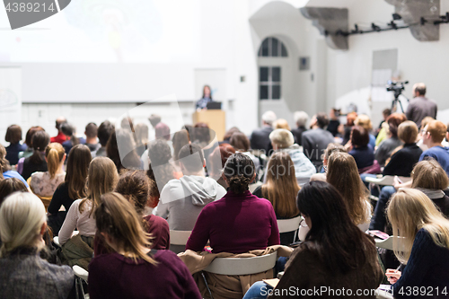 Image of Woman giving presentation in lecture hall at university.