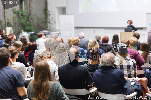 Image of Woman giving presentation in lecture hall at university.