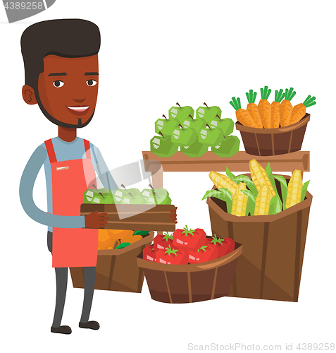 Image of Supermarket worker with box full of apples.