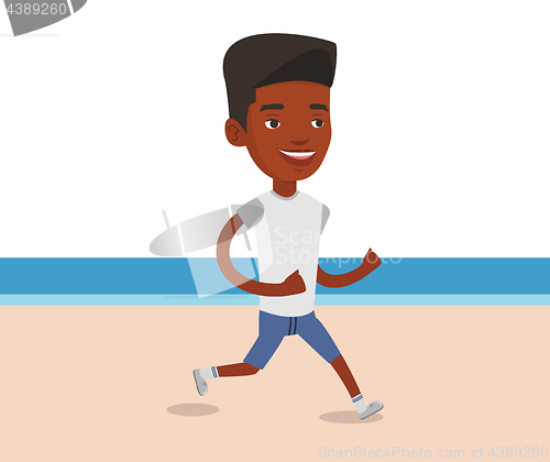 Image of Young sporty man jogging on the beach.