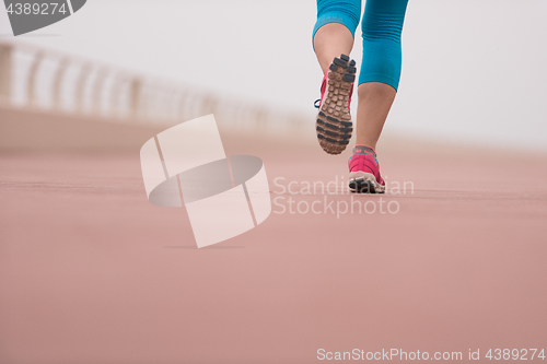 Image of woman busy running on the promenade