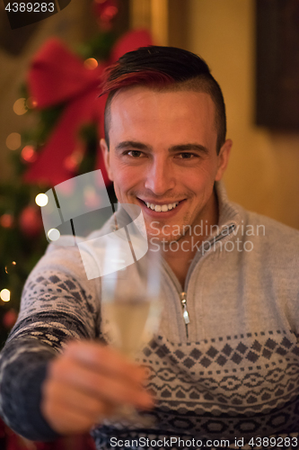 Image of Happy young man with a glass of champagne