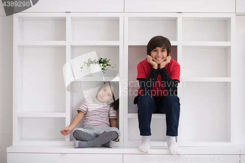 Image of young boys posing on a shelf