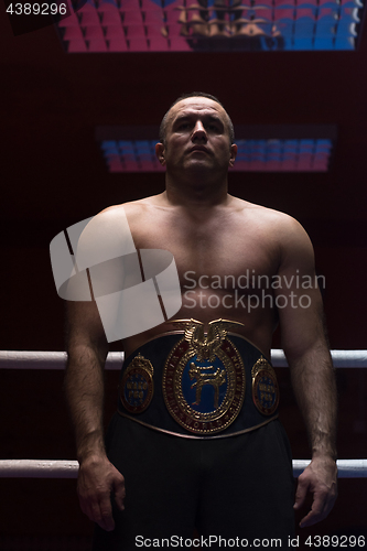 Image of kick boxer with his championship belt