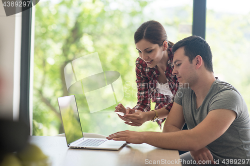 Image of happy young couple buying online