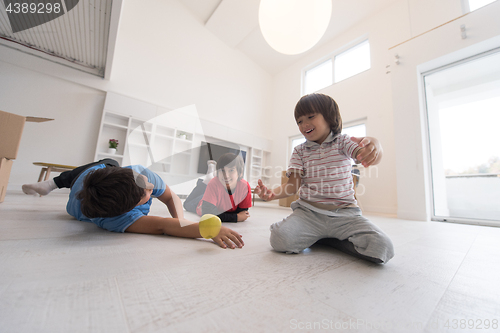 Image of boys having fun with an apple on the floor