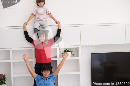 Image of young boys posing line up piggyback