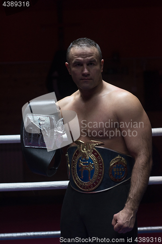 Image of kick boxer with his championship belt