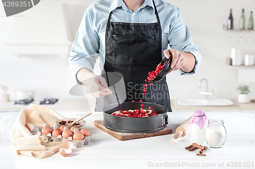 Image of A cook with eggs on a rustic kitchen against the background of men\'s hands