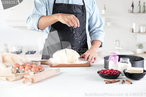 Image of A cook with eggs on a rustic kitchen against the background of men\'s hands