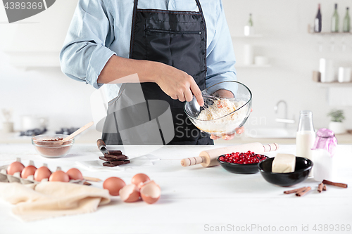 Image of A cook with eggs on a rustic kitchen against the background of men\'s hands