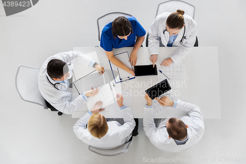 Image of doctors with cardiograms and tablet pc at hospital