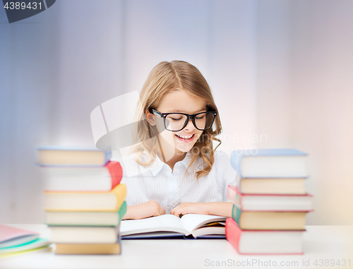 Image of happy smiling student girl reading book