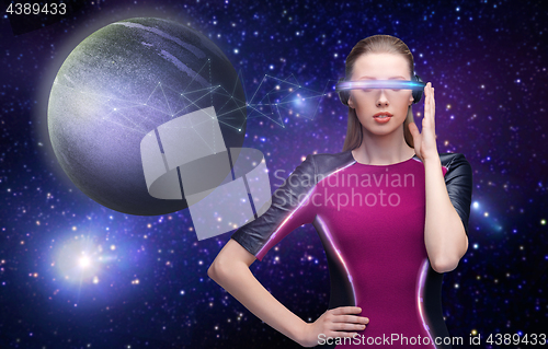 Image of woman in virtual reality glasses over space